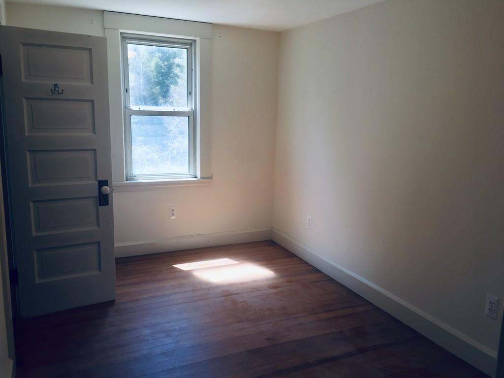 63 Gardner Road Hubbardston, MA 01452 - Photo 23 of 42 an empty room with wooden floor and windows