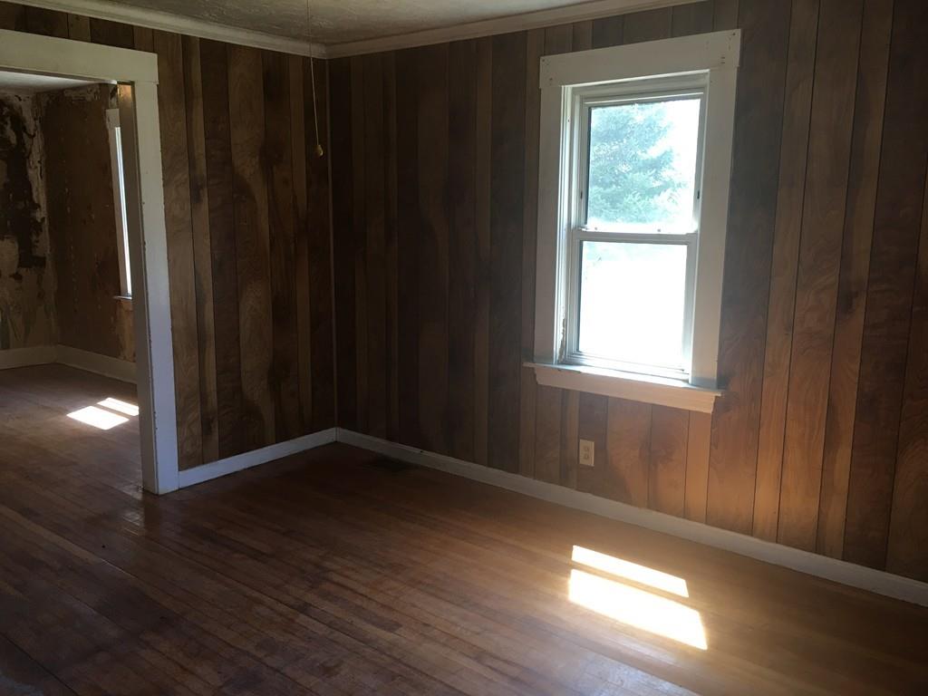 63 Gardner Road Hubbardston, MA 01452 - Photo 10 of 42 a view of an empty room with wooden floor and a window