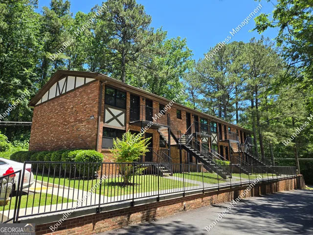 a view of a house with a small yard next to a house