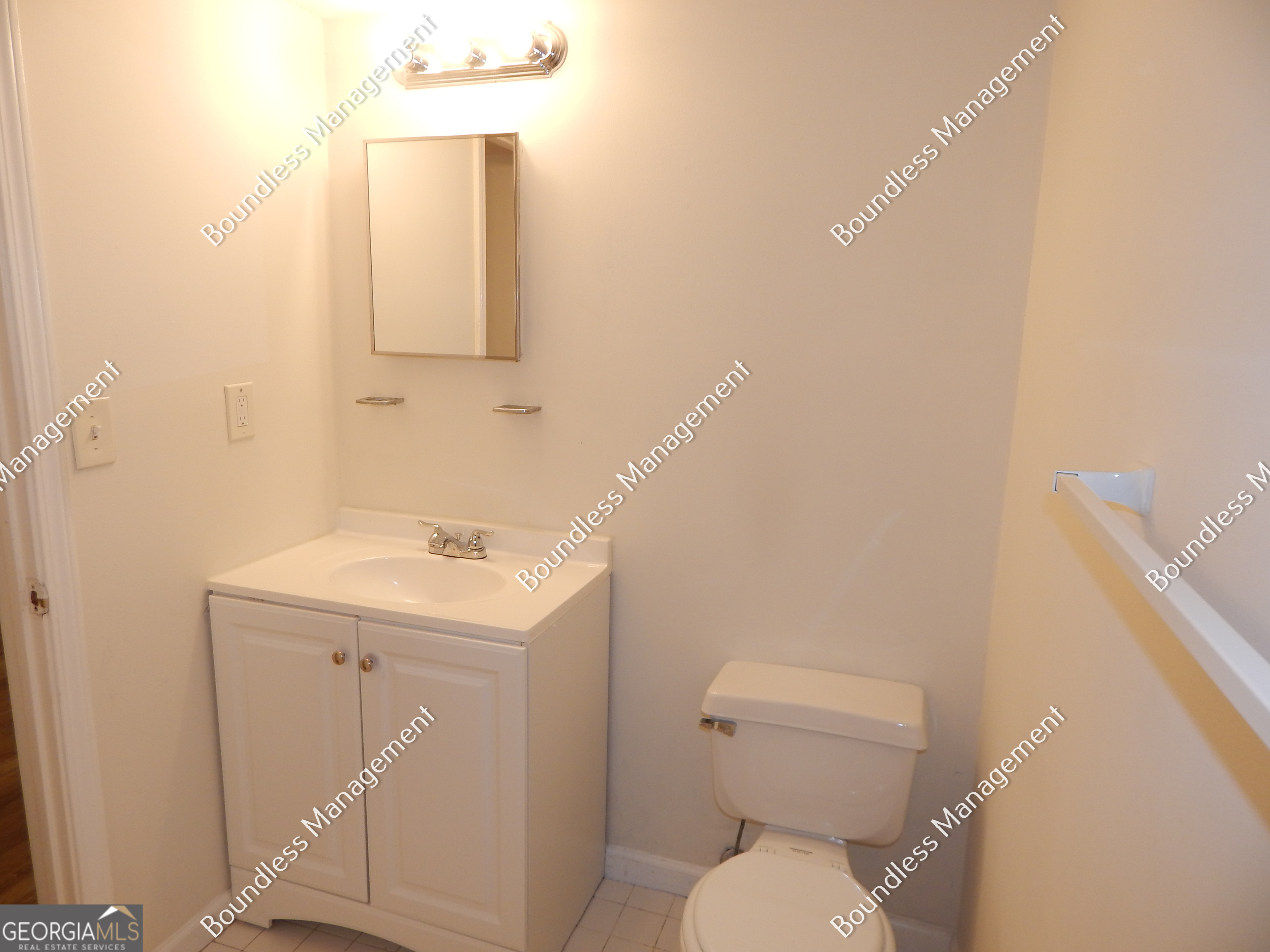 3627 Forrest Park Road Southeast, Unit 25 Atlanta, GA 30354 - Photo 12 of 13 a bathroom with a sink a toilet and a mirror