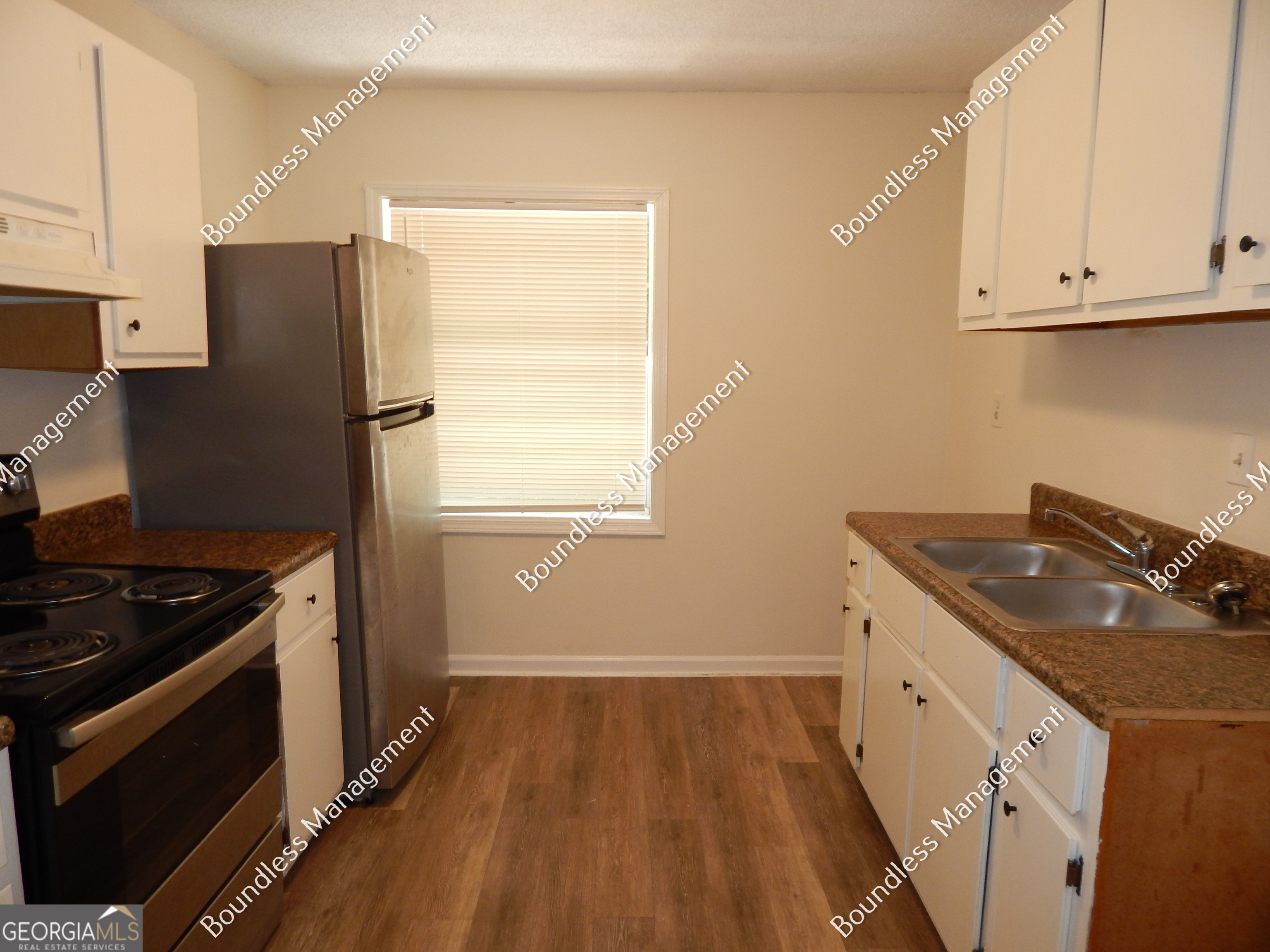 3627 Forrest Park Road Southeast, Unit 25 Atlanta, GA 30354 - Photo 5 of 13 a kitchen with a sink stove and refrigerator