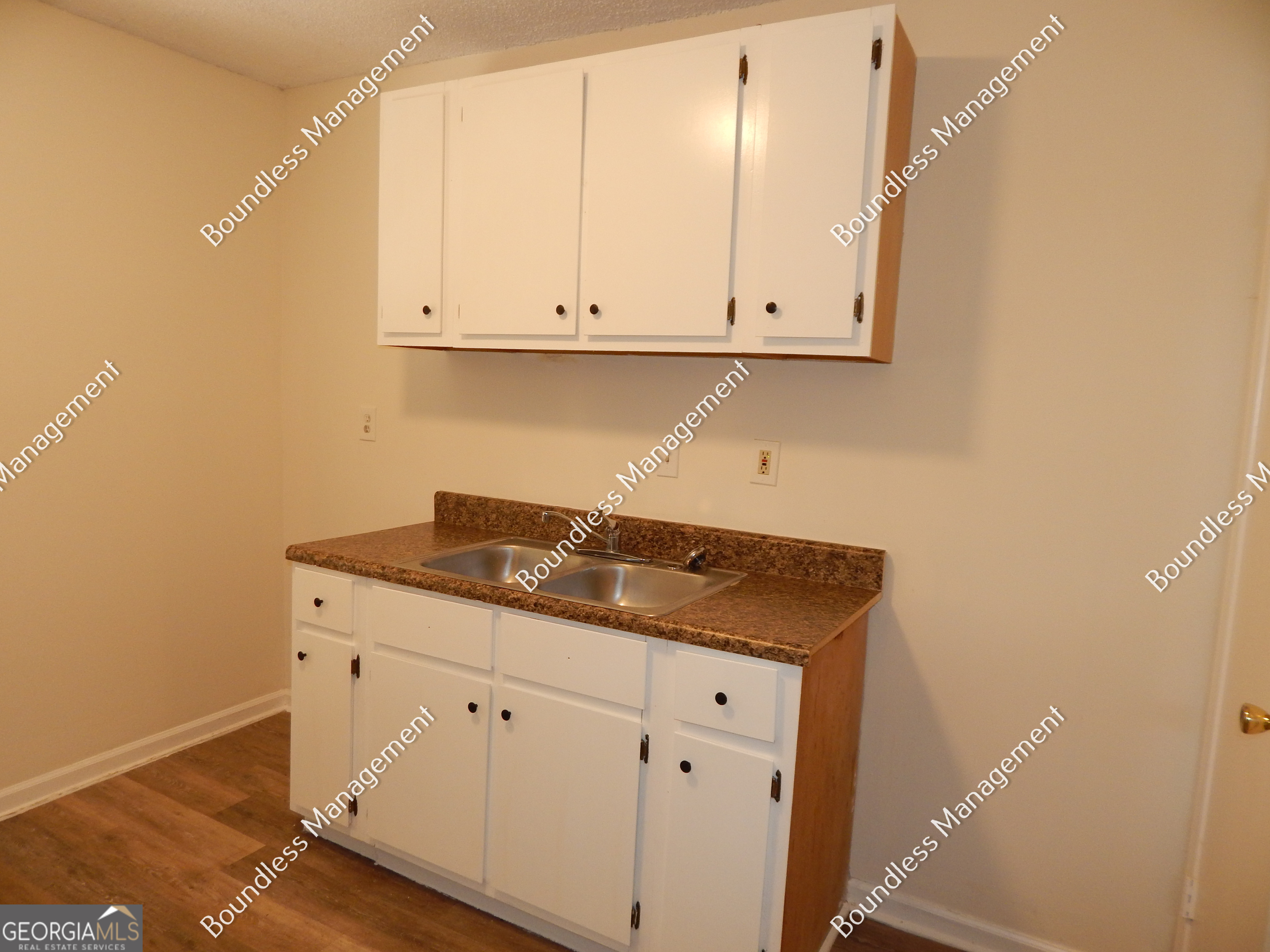 3627 Forrest Park Road Southeast, Unit 25 Atlanta, GA 30354 - Photo 7 of 13 a kitchen with granite countertop white cabinets and a sink