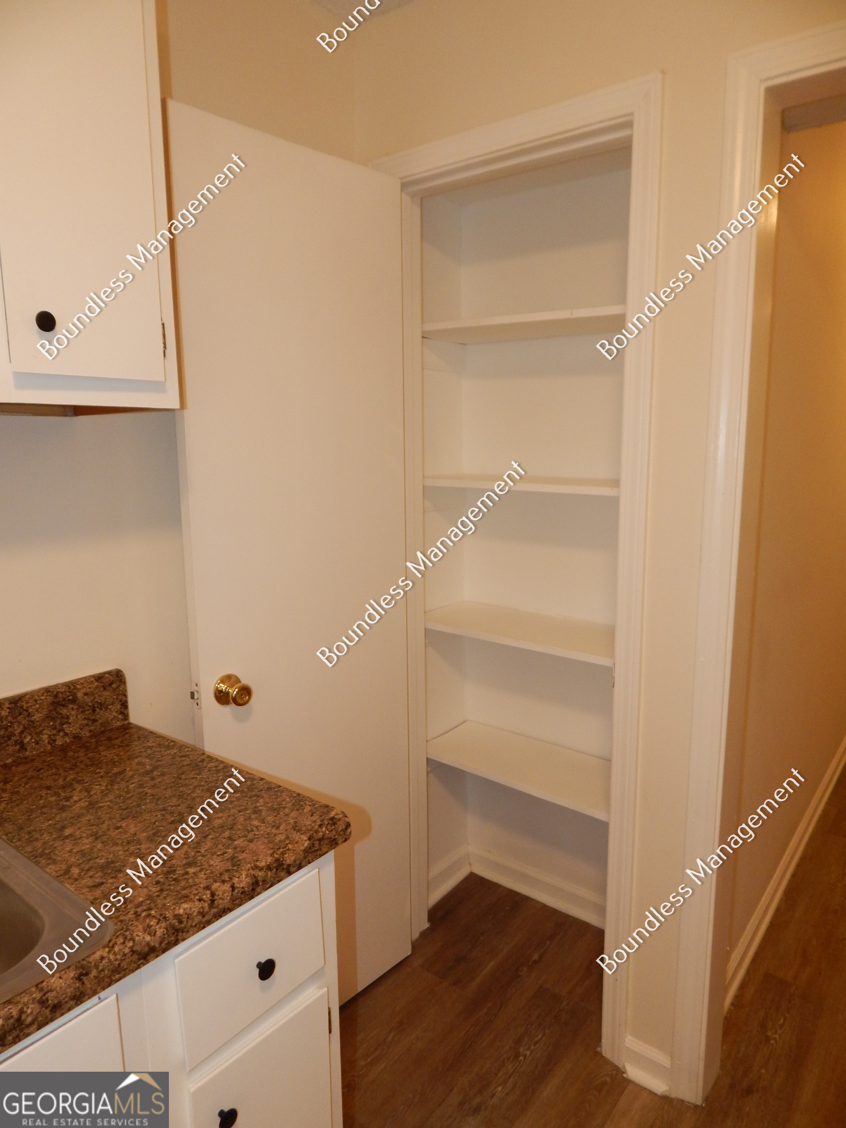 3627 Forrest Park Road Southeast, Unit 25 Atlanta, GA 30354 - Photo 8 of 13 a bedroom with cabinets and wooden floor