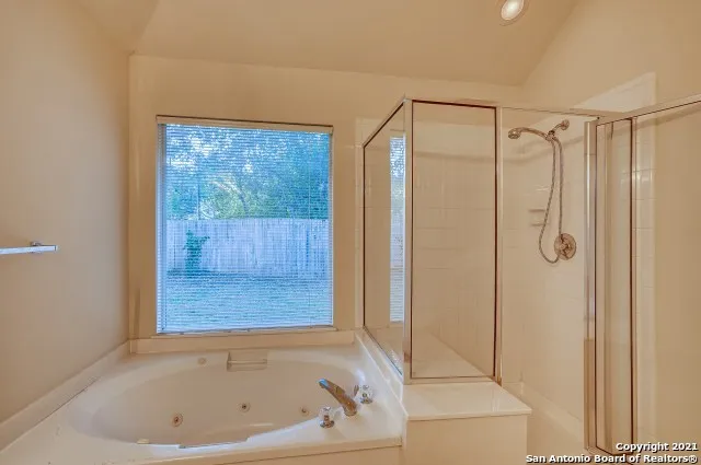 a bathroom with a bathtub and a shower