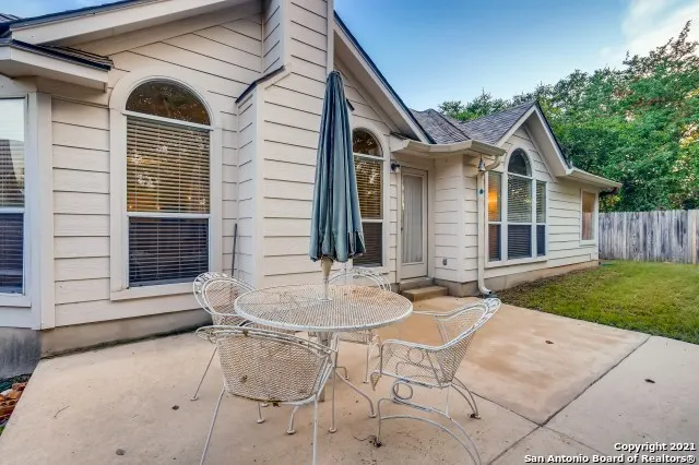 a backyard of a house with table and chairs