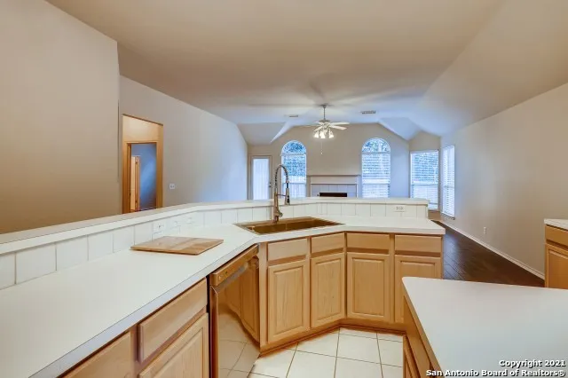 a view of a kitchen with a sink and a wooden floor