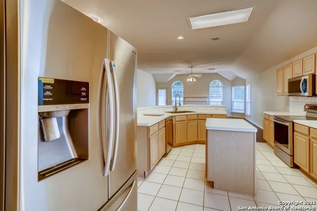 a kitchen with a refrigerator a sink and a stove
