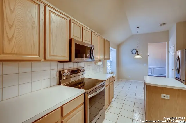 a kitchen that has a microwave a sink and a stove in it
