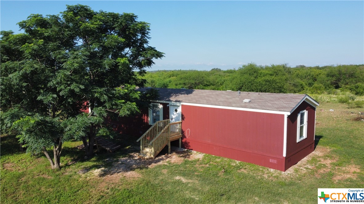 an aerial view of a house with a yard