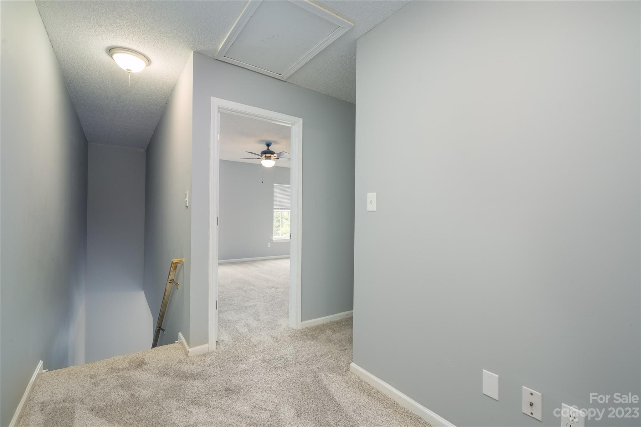 5908 Britt Lane Dallas, NC 28034 - Photo 16 of 22 a view of a hallway with wooden floor and a bathroom