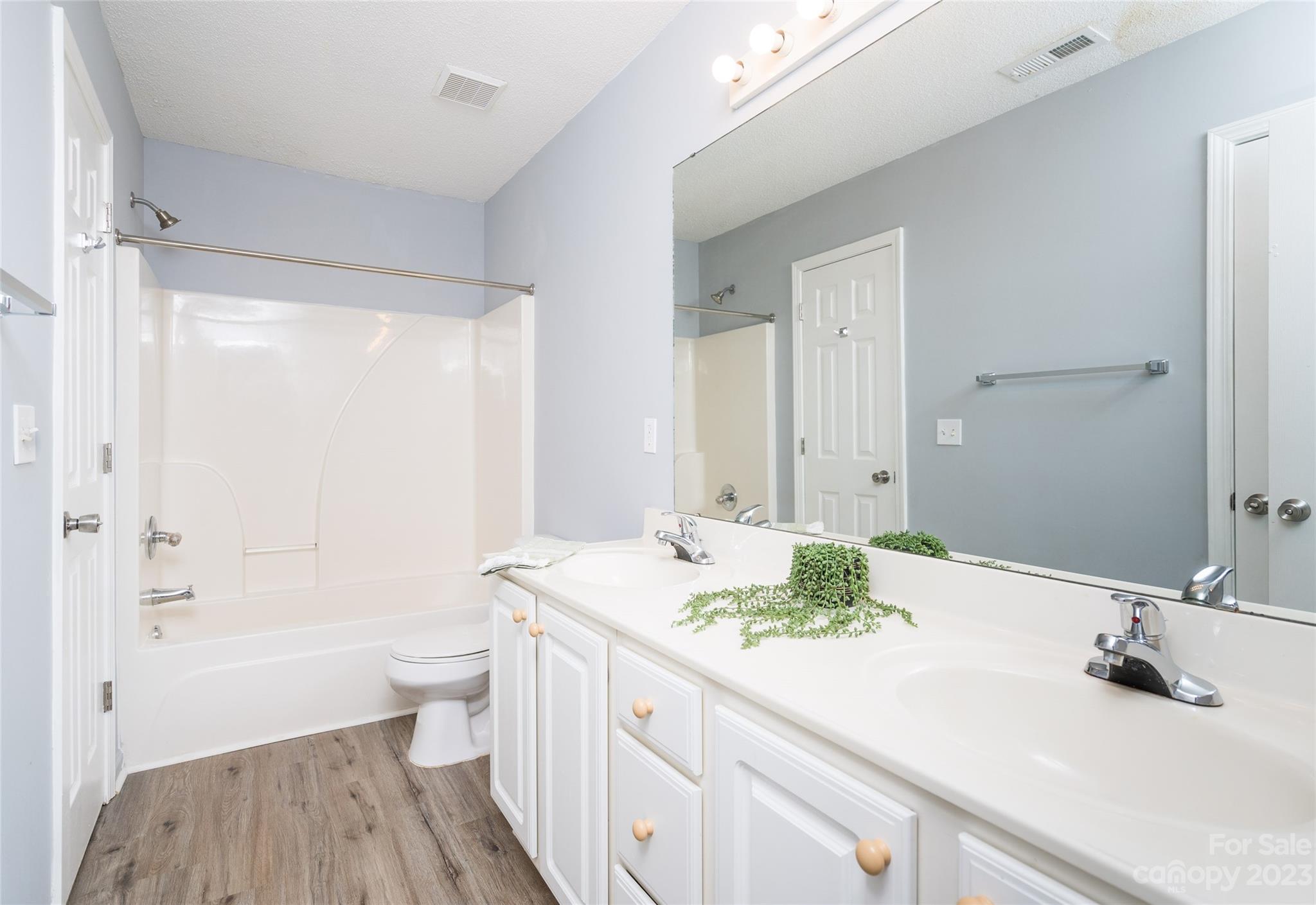 5908 Britt Lane Dallas, NC 28034 - Photo 20 of 22 a bathroom with a granite countertop sink a toilet and shower
