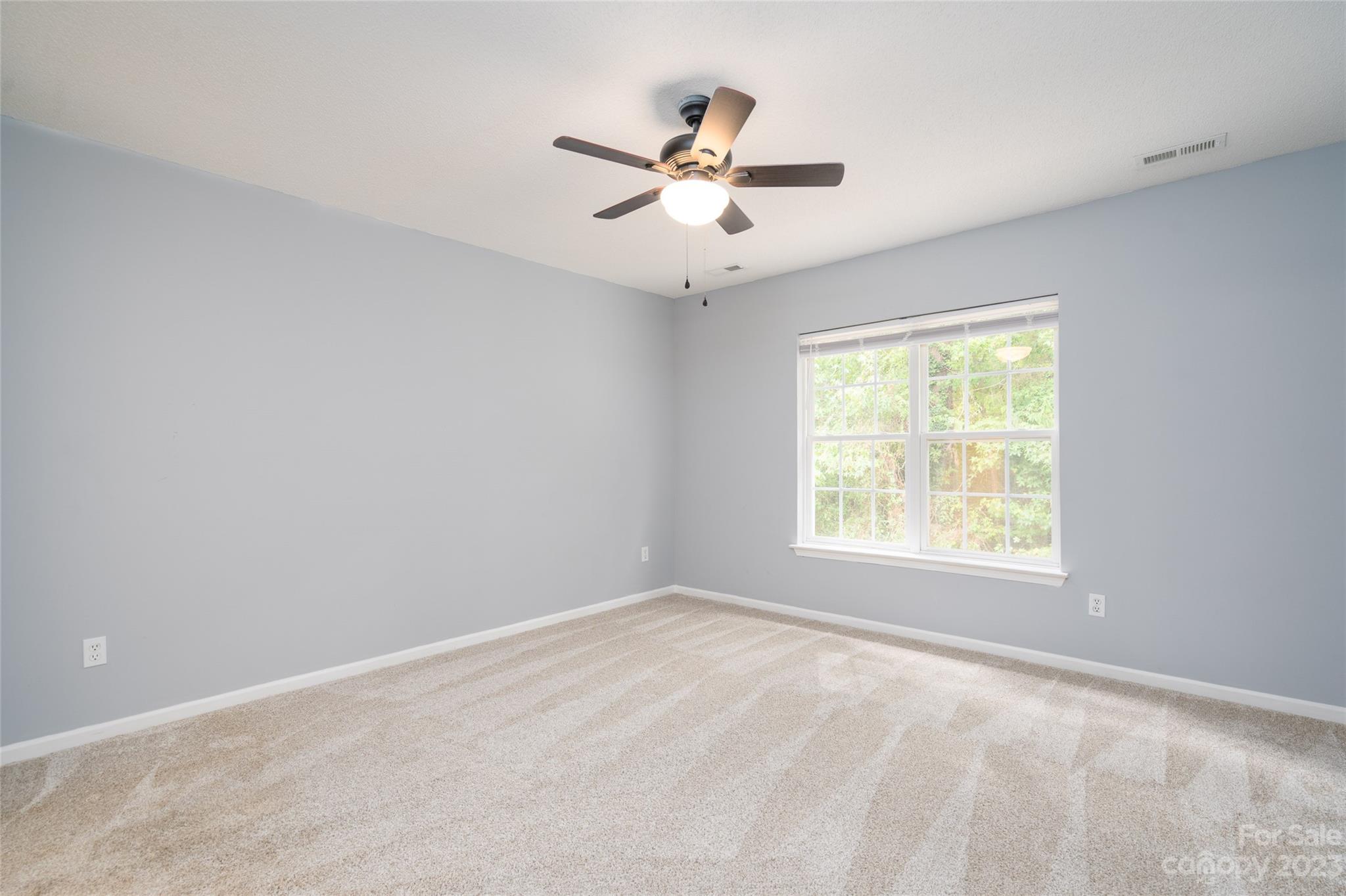 5908 Britt Lane Dallas, NC 28034 - Photo 21 of 22 an empty room with a window and a fan