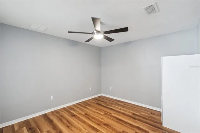 a view of a room with a ceiling fan