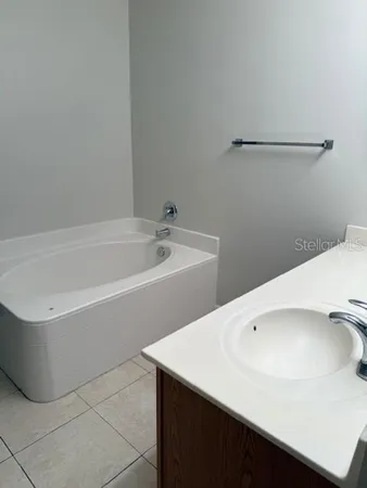 a white bath tub sitting next to a white sink