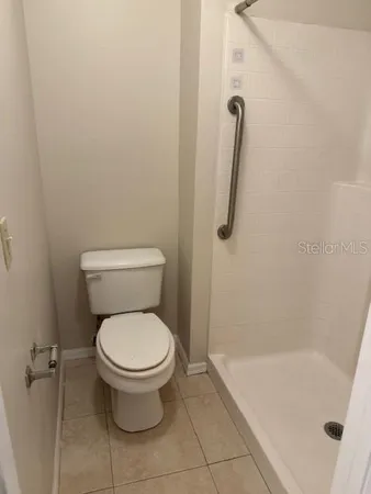 a bathroom with a toilet and a shower