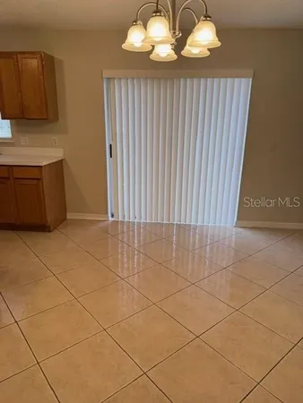 a view of a livingroom with an empty space and a window