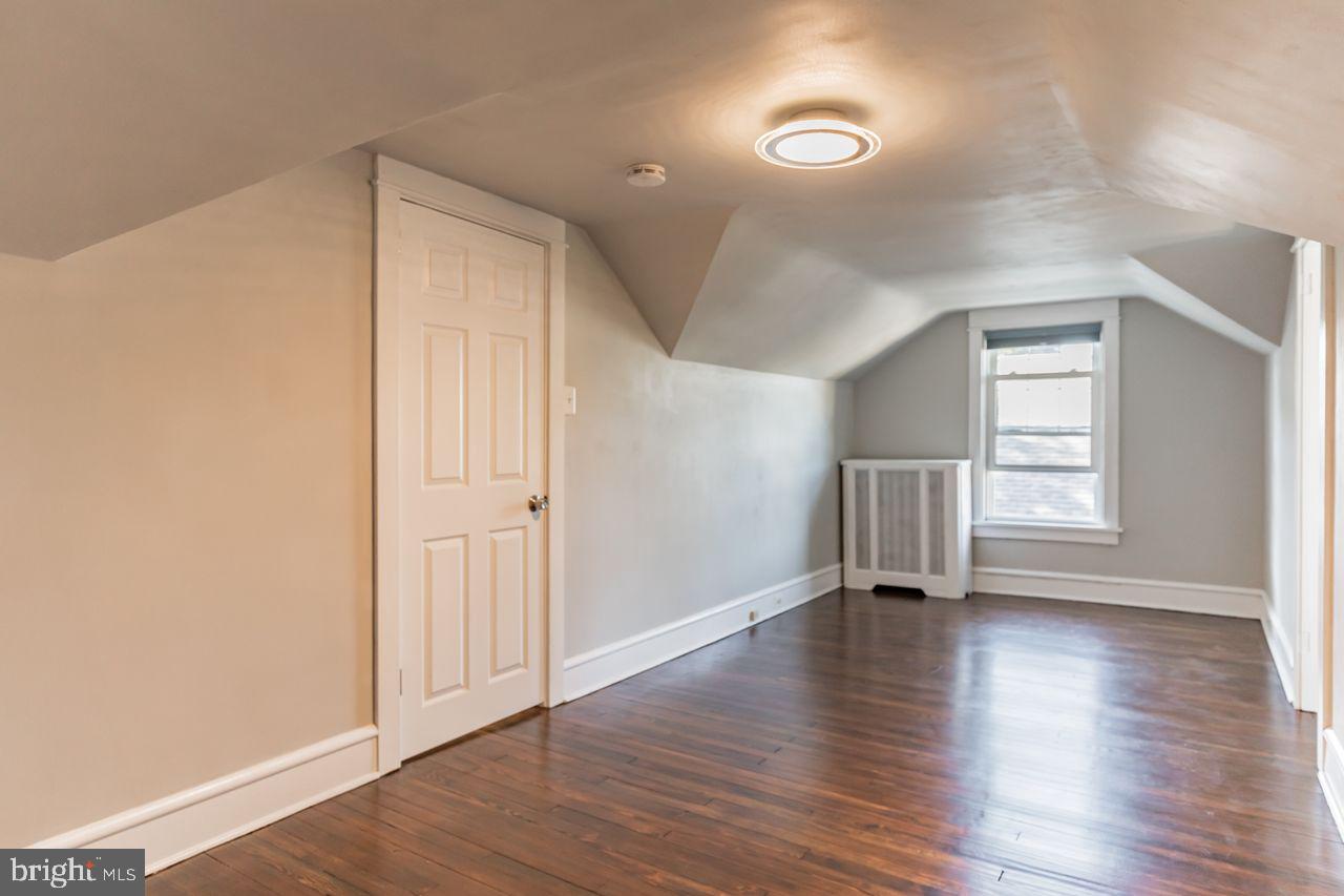 204 Princeton Road Audubon, NJ 08106 - Photo 13 of 22 a view of an empty room with wooden floor and a window