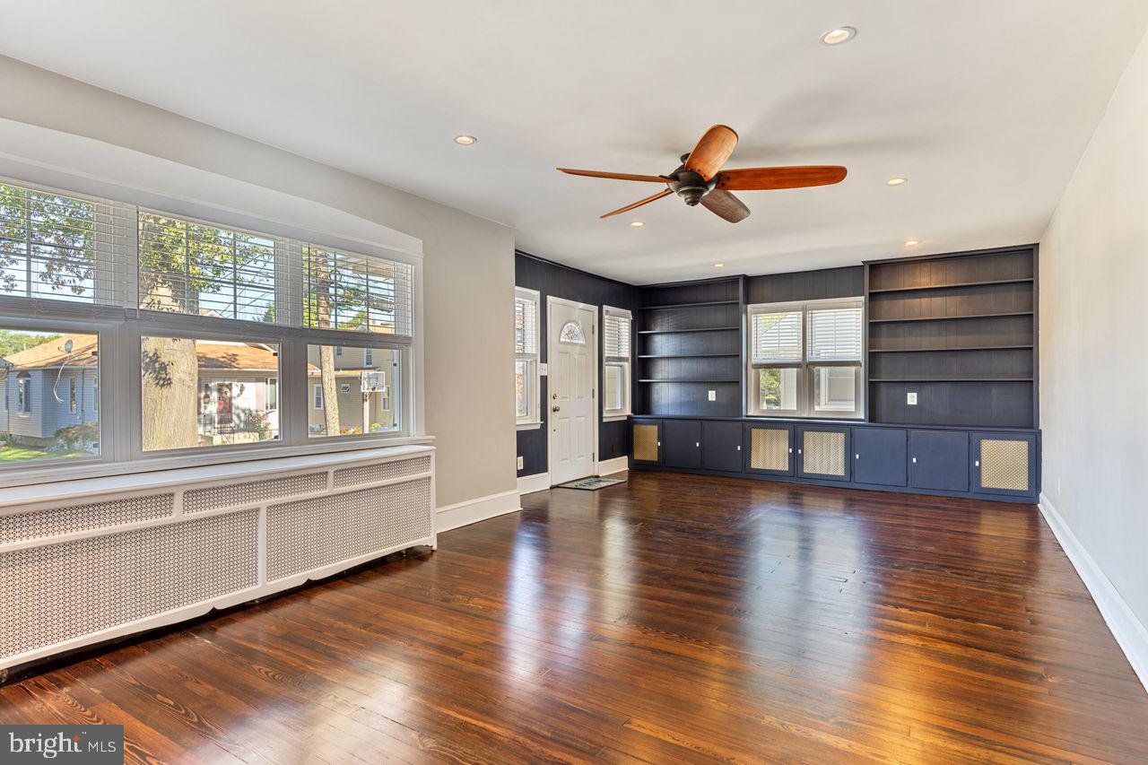 204 Princeton Road Audubon, NJ 08106 - Photo 3 of 22 a view of empty room with wooden floor and fan