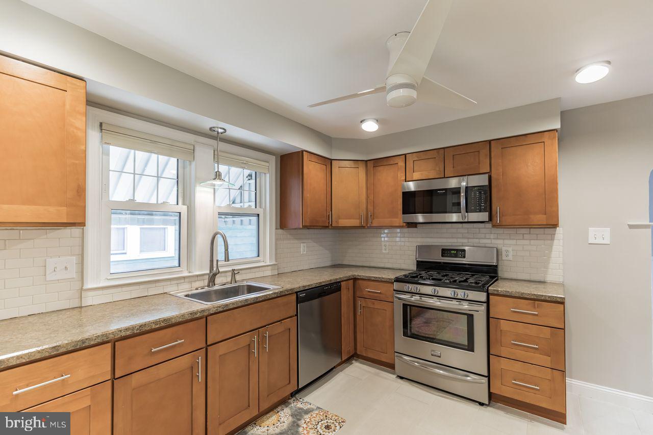 204 Princeton Road Audubon, NJ 08106 - Photo 6 of 22 a kitchen with stainless steel appliances granite countertop a stove and a sink