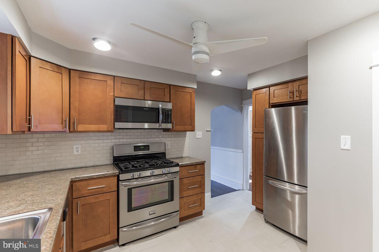 204 Princeton Road Audubon, NJ 08106 - Photo 7 of 22 a kitchen with stainless steel appliances granite countertop a refrigerator stove and microwave