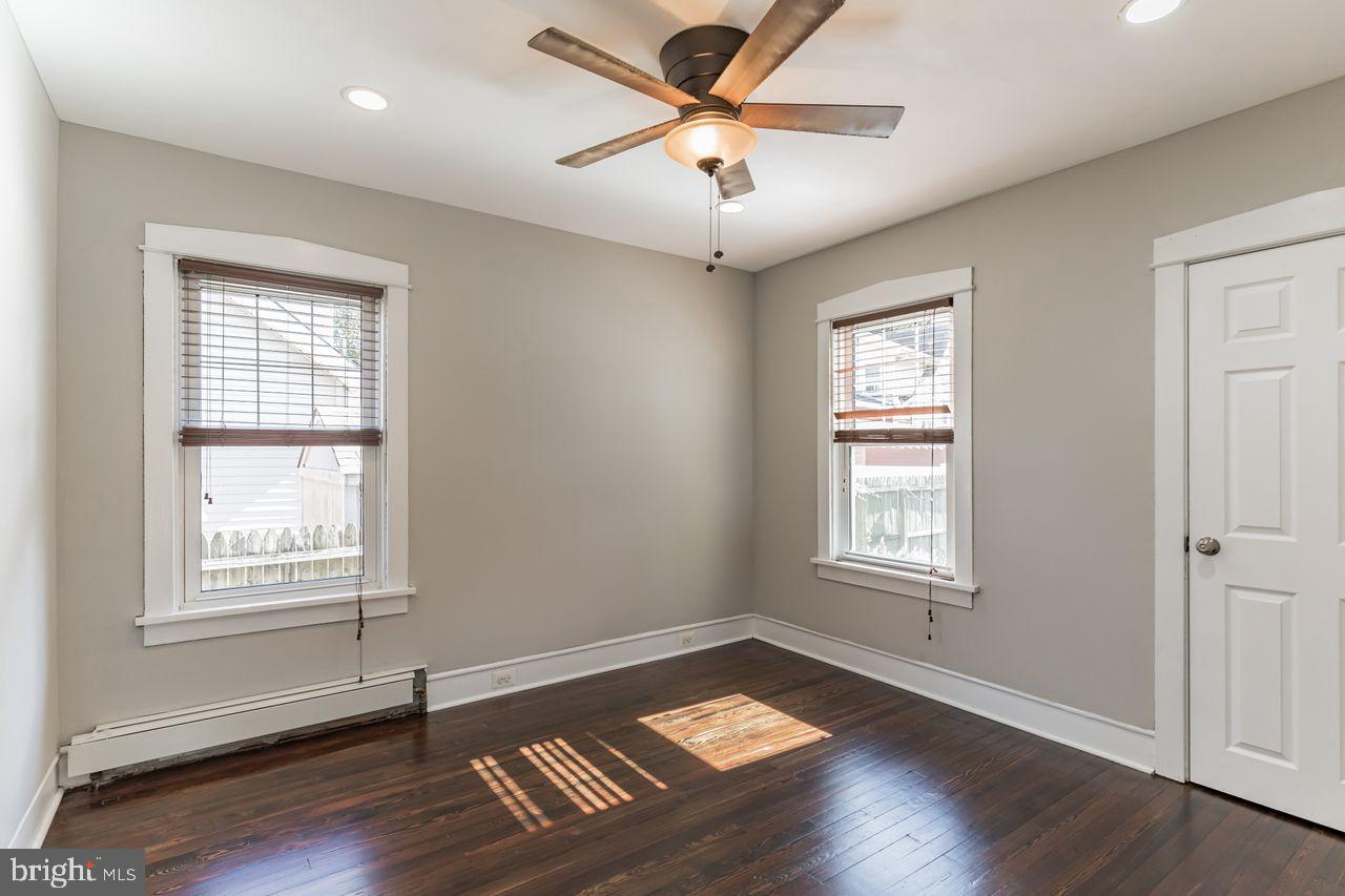 204 Princeton Road Audubon, NJ 08106 - Photo 8 of 22 a view of an empty room with wooden floor and a window
