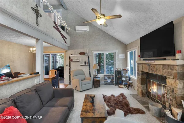 a living room with furniture fireplace and flat screen tv