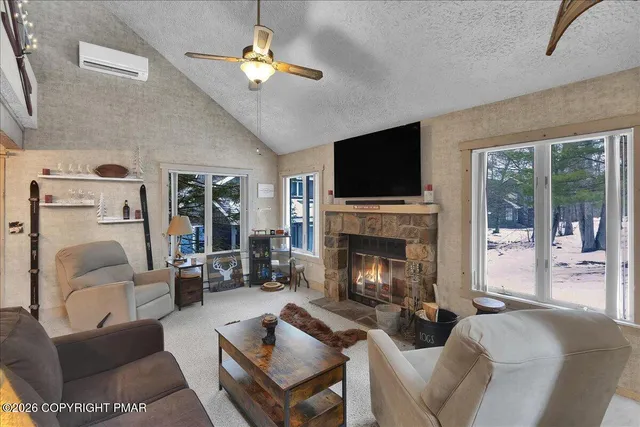 a living room with furniture a fireplace and a flat screen tv