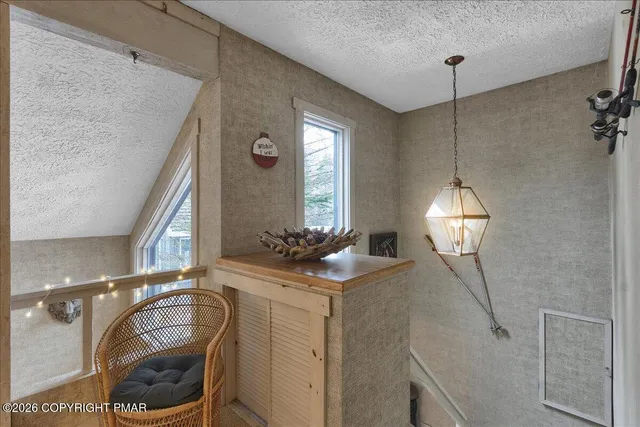 a bathroom with a granite countertop sink vanity mirror and toilet
