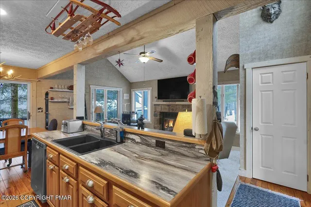 a living room with stainless steel appliances furniture and a large window