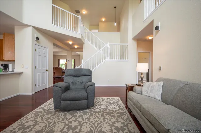 a living room with furniture and a ceiling fan