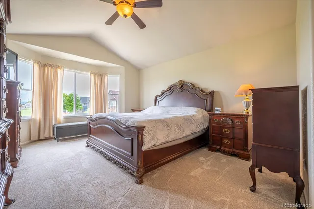 a bedroom with a bed and a chair