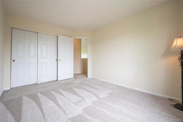 a view of a room with a bed and cabinets