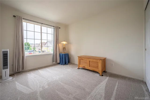 an empty room with windows and closet