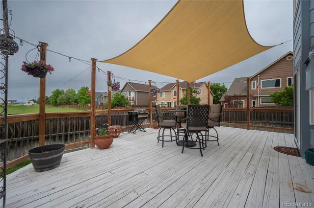 a view of a patio with a table and chairs