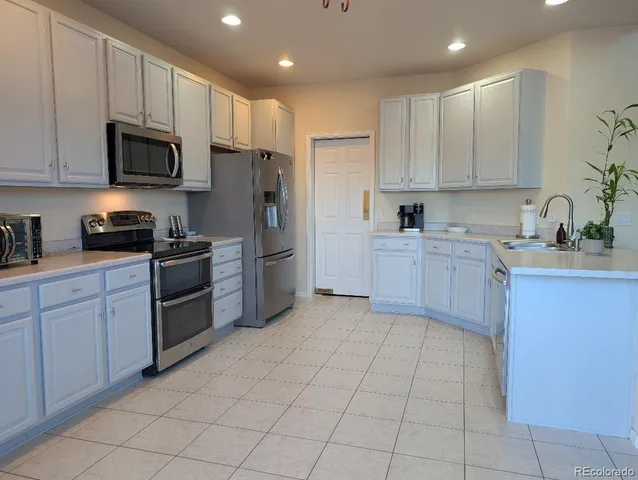 a kitchen with a sink a microwave and refrigerator