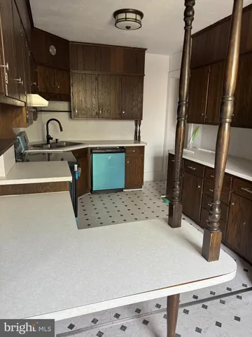 a kitchen with granite countertop a sink and a stove