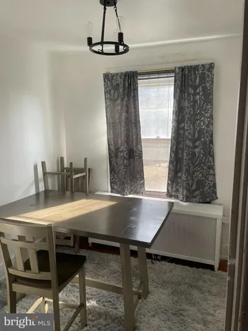 a view of a dining room with furniture and window