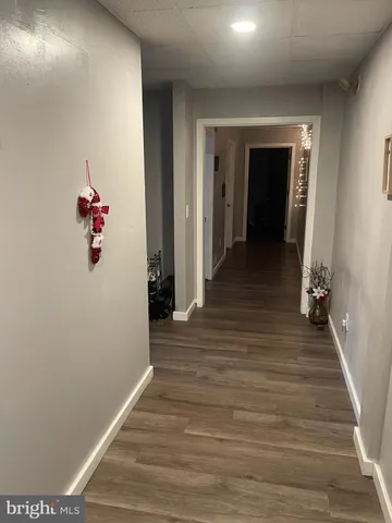 a view of a hallway view with wooden floor and staircase