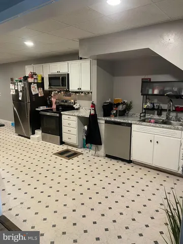 a kitchen with a sink cabinets and appliances