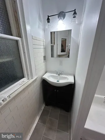 a bathroom with a sink a mirror and a shower