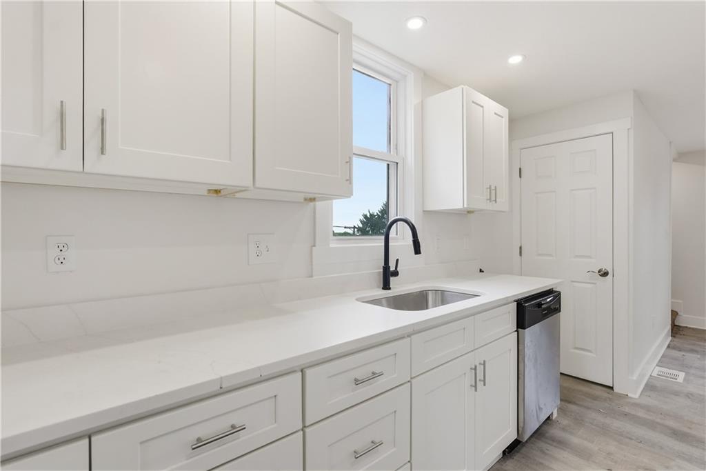 480 Songo Street Pittsburgh, PA 15227 - Photo 18 of 36 a kitchen with white cabinets and a sink