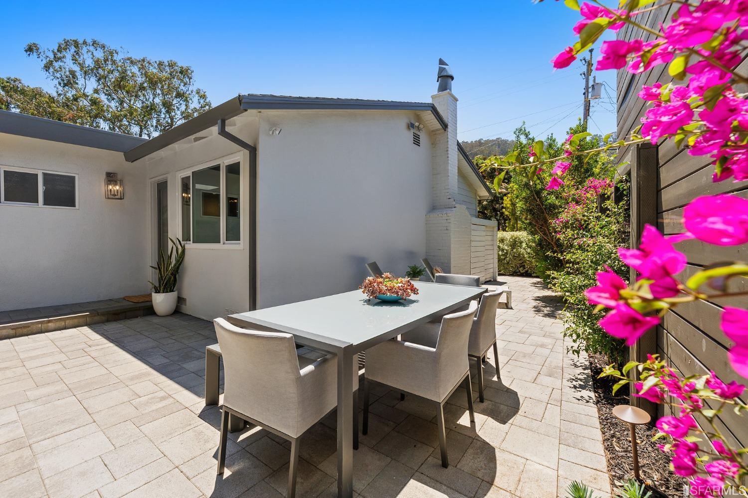 1615 Linda Mar Boulevard Pacifica, CA 94044 - Photo 15 of 41 a table and chairs in front of a house