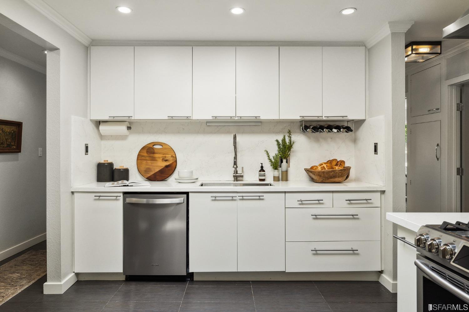 1615 Linda Mar Boulevard Pacifica, CA 94044 - Photo 19 of 41 a kitchen with white cabinets and a stove with wooden floor