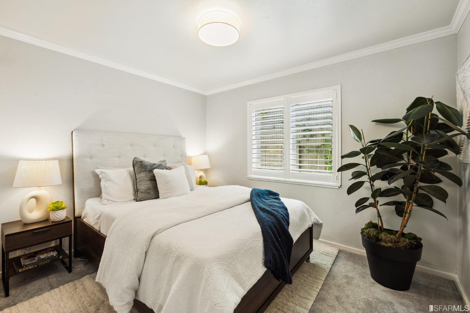 1615 Linda Mar Boulevard Pacifica, CA 94044 - Photo 36 of 41 a bedroom with a bed a potted plant and a window