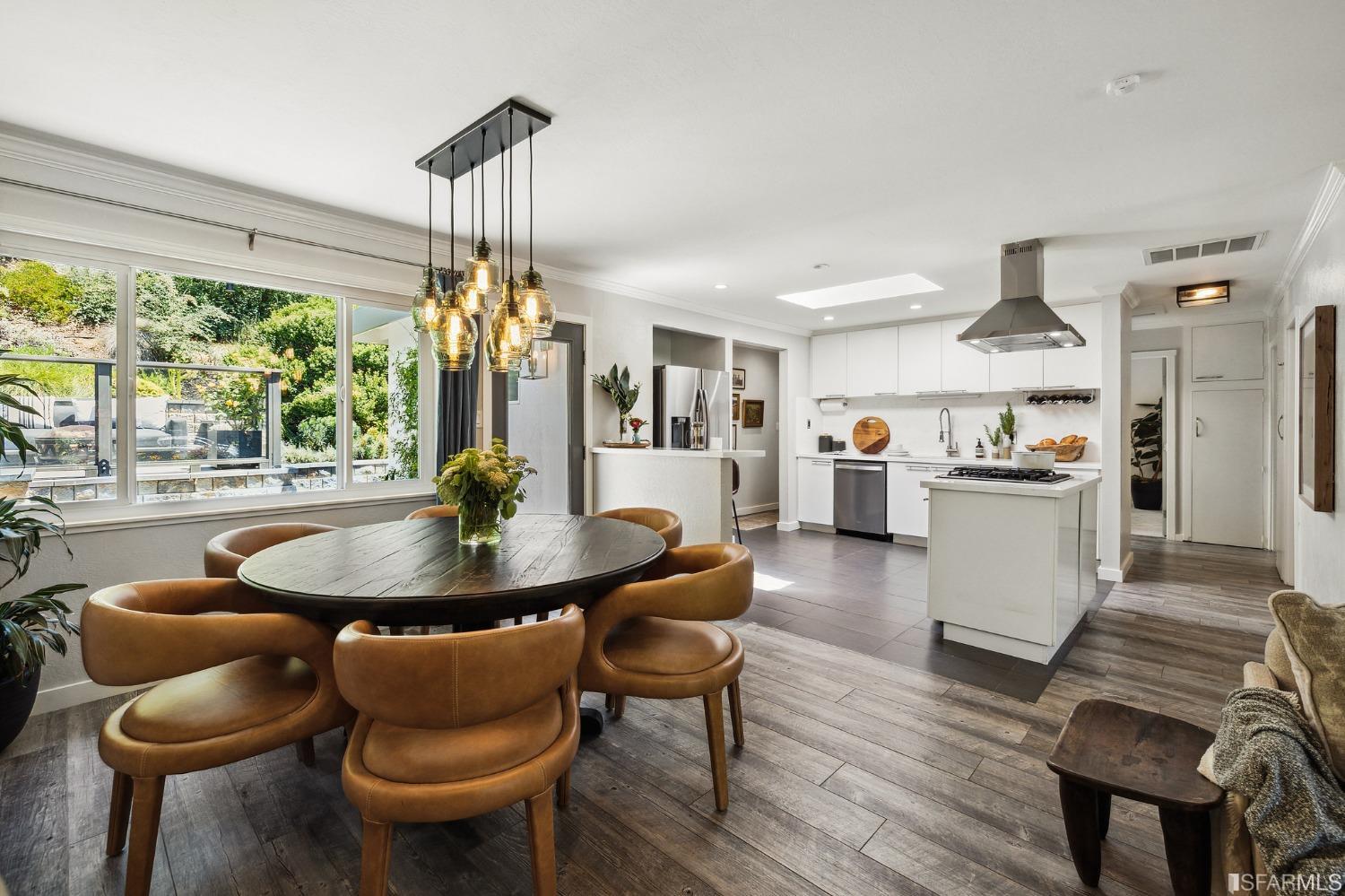 1615 Linda Mar Boulevard Pacifica, CA 94044 - Photo 9 of 41 a dining room with furniture a chandelier and wooden floor