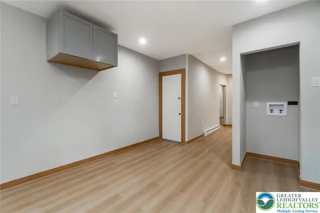 a view of an empty room with wooden floor