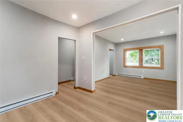 an empty room with windows and closet