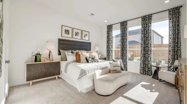 a bed room with bed and large window