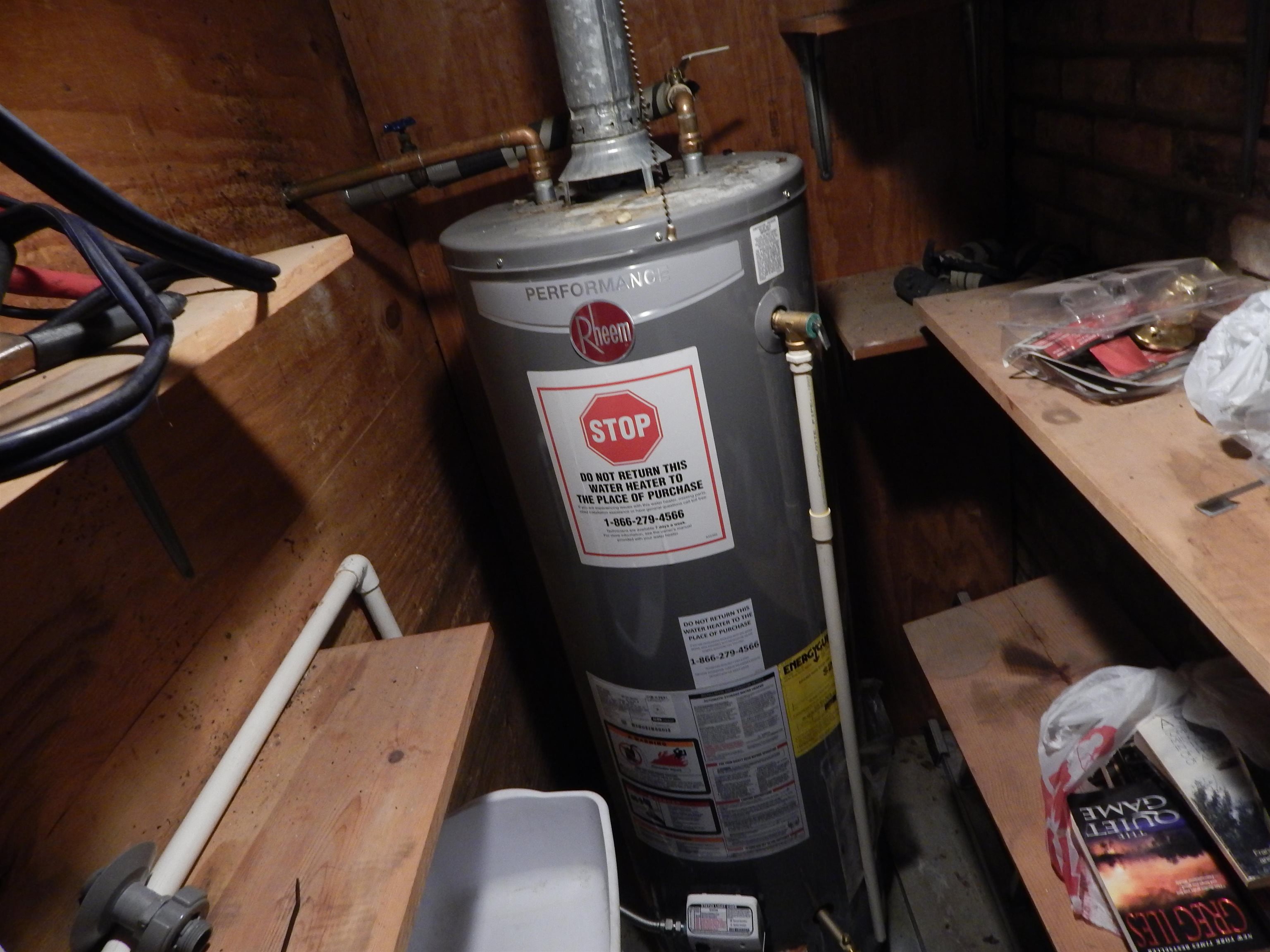 4956 Cottonwood Road Memphis, TN 38118 - Photo 13 of 13 Water heater installation with exposed plumbing and wood-paneled walls