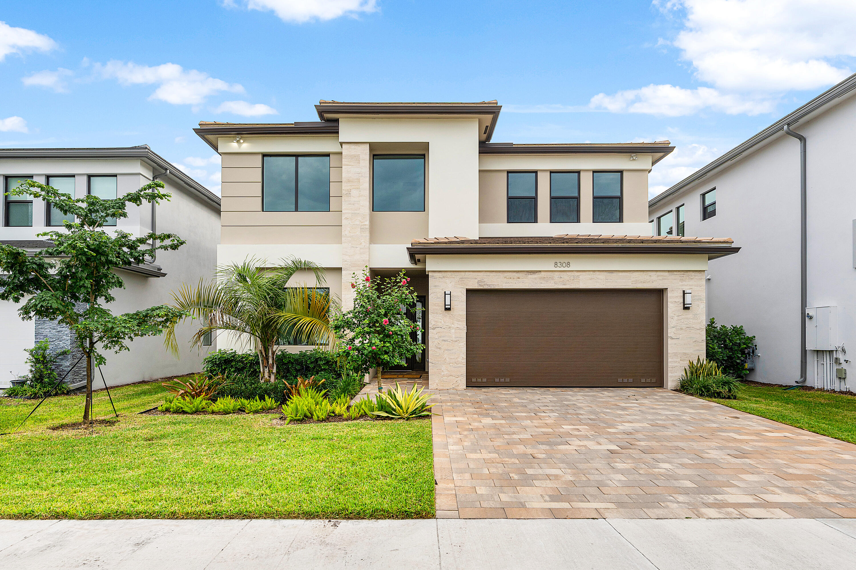 a front view of a house with a yard and garage
